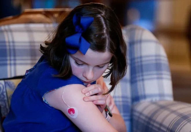 Sixth-grader Ellie Rowe, who has diabetes, show where her insulin pump connects to her arm.